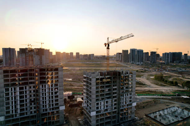istock Tower crane on construction site on sunset background. Arial view of the cranes the conctruct the high-rise building. 1330594356