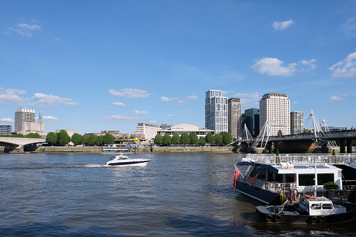 London, England, UK - June 17 2021: View of the River Thames from Victoria Embankment. Waterloo Bridge, Hayward Gallery, Festival Pier, Royal Festival Hall, Golden Jubilee Bridge are seen on the South Bank.