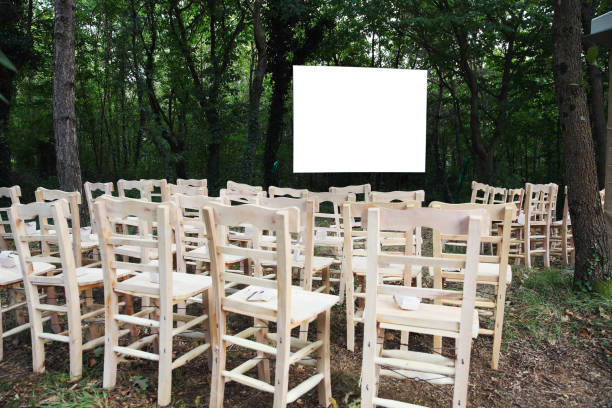 istock Chairs with white screen on a background of trees forest. 1330594384
