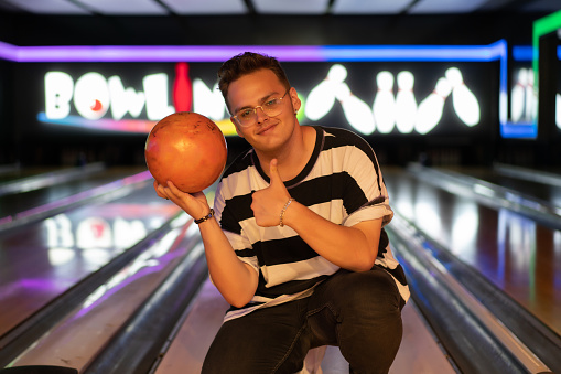 Young attractive man in bowling