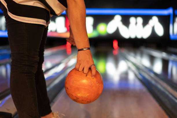 istock Man's hand holding a bowling ball ready to throw it 1330597559
