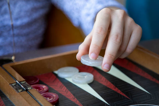 young man playing backgammon - backgammon imagens e fotografias de stock