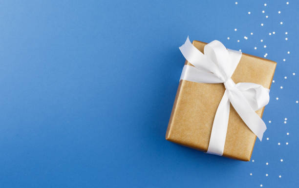 istock Gift box in craft paper with confetti from stars 1330598269