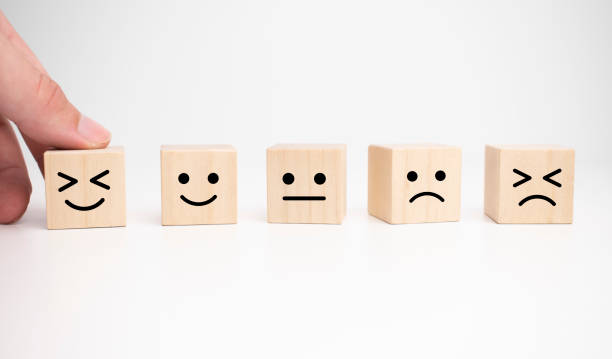 istock Customer service evaluation and satisfaction survey concepts. The client's hand picked the happy face smile face symbol on wooden cube, copy space 1330598369