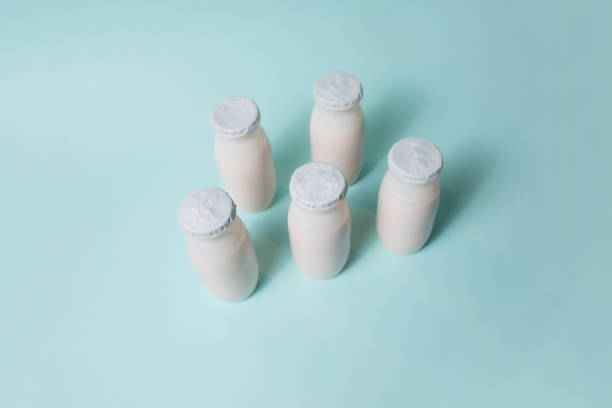 istock Bottles with probiotics and prebiotics dairy drink on light blue background. 1330600829