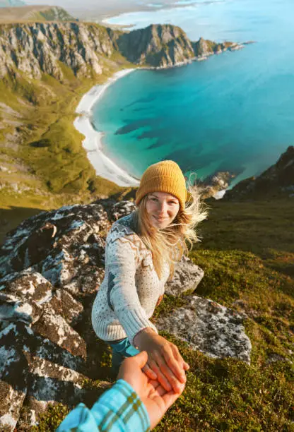 Photo of Cheerful woman follow holding hand her boyfriend couple travel vacations friends having fun outdoor hike tour in Norway adventure lifestyle aerial view ocean beach