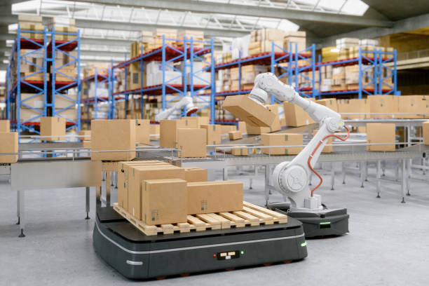 Automated Robot Carriers And Robotic Arm In Modern Distribution Warehouse Automation with AGV and robotic arm in modern distribution warehouse. robotic arm stock pictures, royalty-free photos & images