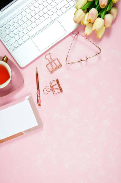 istock Feminine pink desktop workspace blog header overhead flat lay. 1330604358