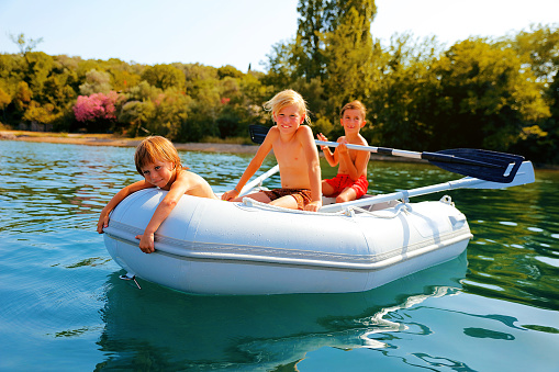 Kids having a good time on boat during summer vacation.