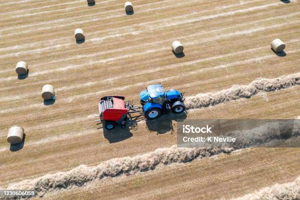 Tractor And Hay Baler At Work Stock Photo - Download Image Now - Bale, Tractor, Preparation