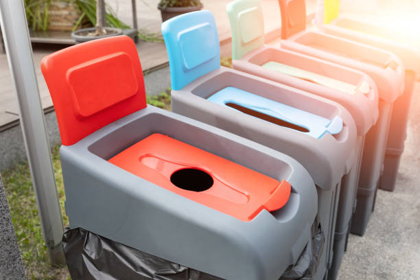 istock Row of many different multicolored plastic waste cans for garbage sorting and recycling at city street outdoors. Environmental protection and nature cotamination danger prevention concept 1330606716