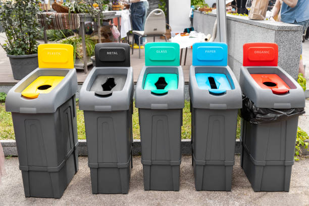 istock Row of many different multicolored plastic waste cans for garbage sorting and recycling at city street outdoors. Environmental protection and nature cotamination danger prevention concept 1330606717