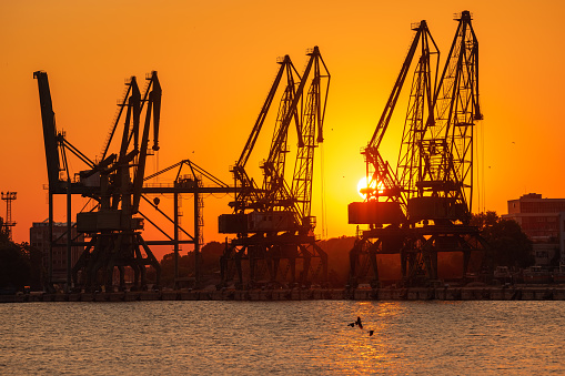 Sunset over sea port and industrial cranes, Varna, Bulgaria