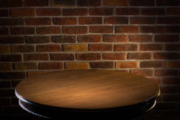 istock Selected focus empty black wooden table and wall texture or old brick wall blur background image. 1330607669