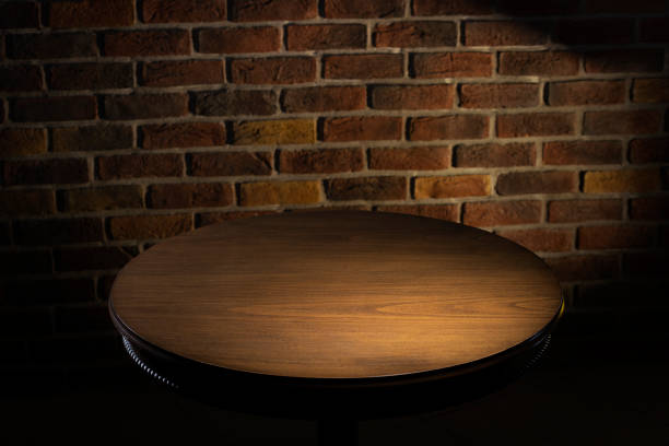 istock Selected focus empty black wooden table and wall texture or old brick wall blur background image. 1330607683