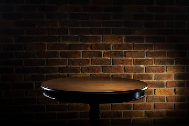 Selected focus empty black wooden table and wall texture or old brick wall blur background image.