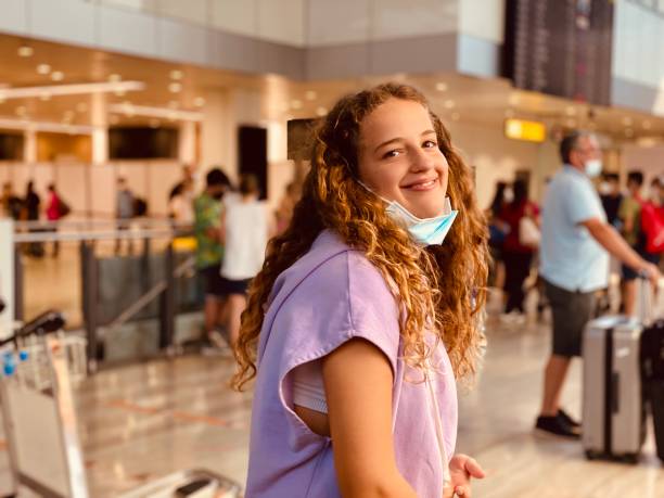istock Smiling girl on airport. 1330608324