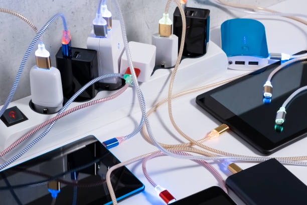 istock Charging hub on the Table, micro usb   wires to chargers in sockets. Extension cord switch loaded with Charger adapters and cables 1330611426