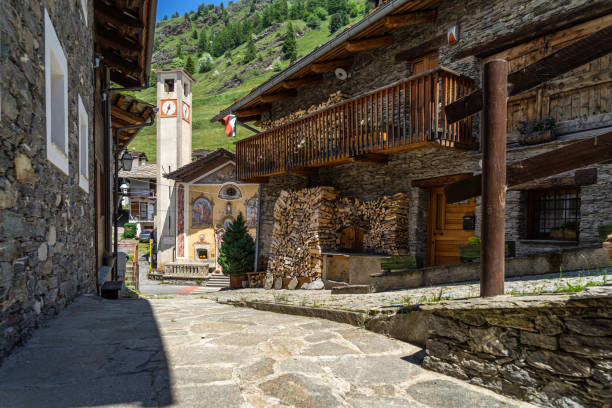 View of alpine houses and church in Pontechianale, a typical village in Varaita Valley, Piedmont, Italy View of alpine houses and church in Pontechianale, a typical village in Varaita Valley, Piedmont, Italy cuneo stock pictures, royalty-free photos & images