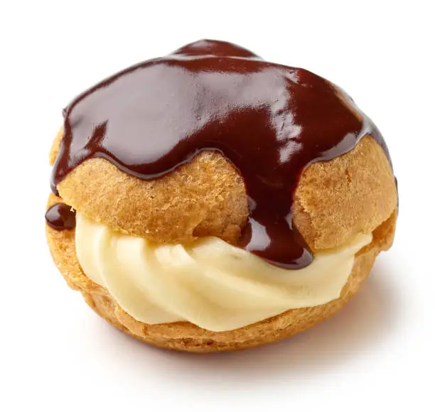 Photo of cream puff with custard cream covered with melted chocolate