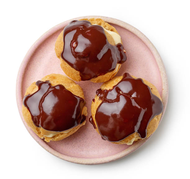 istock pink plate of cream puffs 1330613158