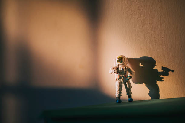 istock toy astronaut standing against wall with harsh shadow 1330615672