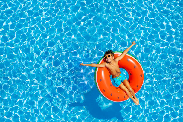 istock Boy swim on inflatable ring view from above 1330615933