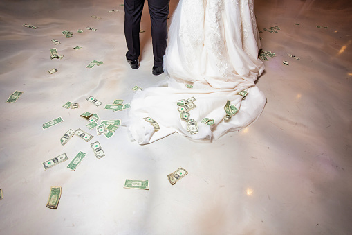 Money is on a floor as part of the wedding tradition.