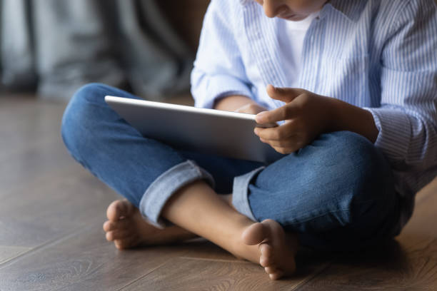 istock Gen Z kid sitting on heating floor at home 1330622469