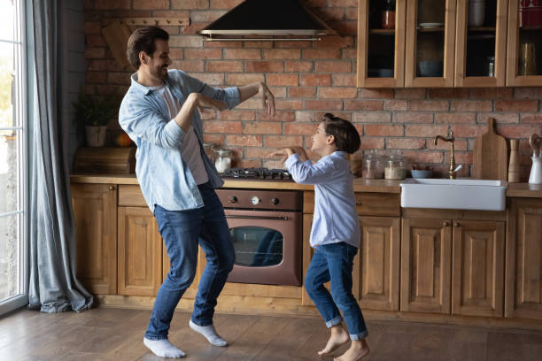 istock Happy dad teaching excited cute preschooler son to dance 1330622473