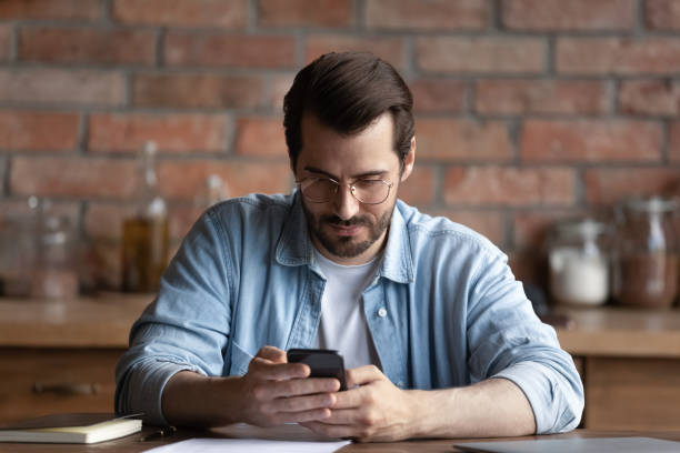 istock Focused man using mobile service, online app on smartphone 1330623009