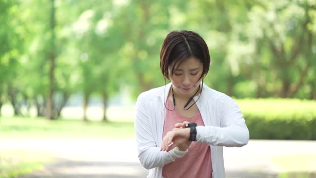 A woman jogging while listening to music on her smartphone