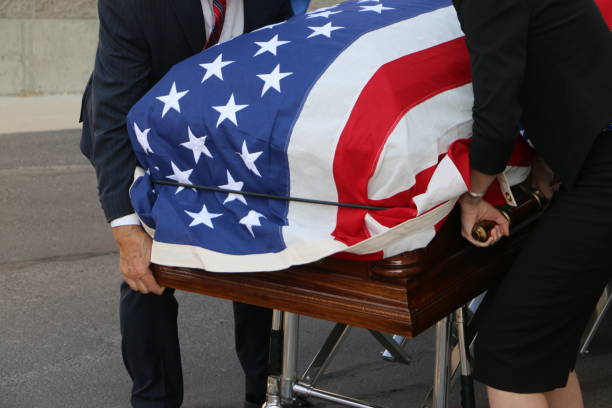 istock Casket draped with American flag removed from hearse 1330627059