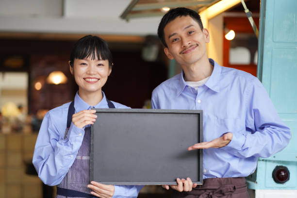 istock A couple holding a message board in front of a kitchen car 1330630612