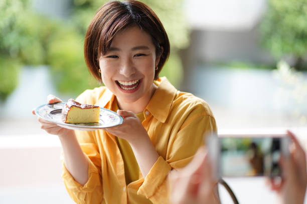 istock Woman holding a cake and taking a picture 1330630697