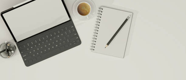 istock Smart tablet with keyboard, note book, pencils and coffee in white background, copy space 1330631679