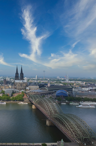 Aerial view of the Cologne Cathedral with the Hohenzollern Bridge and river Rhine in the foreground on a sunny day in Cologne, Germany