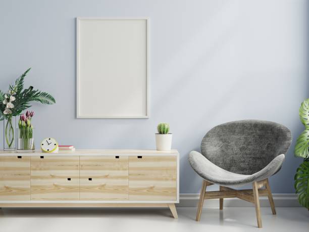 istock Poster mockup with vertical frame on empty blue wall in living room interior with armchair. 1330635968