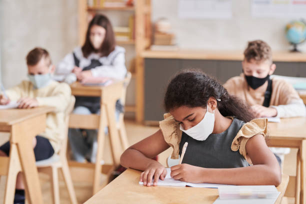 istock Girl Wearing Mask in Class 1330639678
