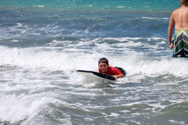 istock Young Boy Body Boarding in Sea in Summer 1330641981