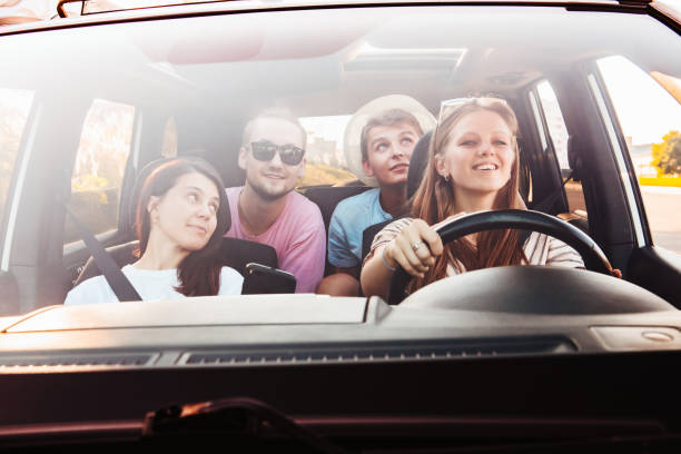 istock four friends in car navigation on phone 1330642572
