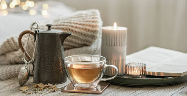 istock Cozy composition with a cup of tea and a teapot on a blurred background. 1330643617