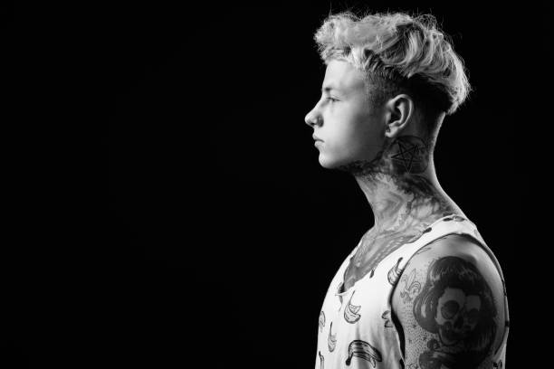 istock Young handsome rebellious man with blond hair in black and white 1330644563