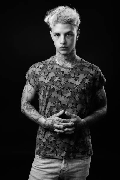 istock Young handsome rebellious man with blond hair in black and white 1330644643