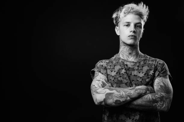 istock Young handsome rebellious man with blond hair in black and white 1330644666