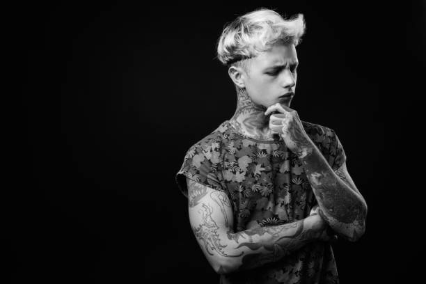 istock Young handsome rebellious man with blond hair in black and white 1330644790
