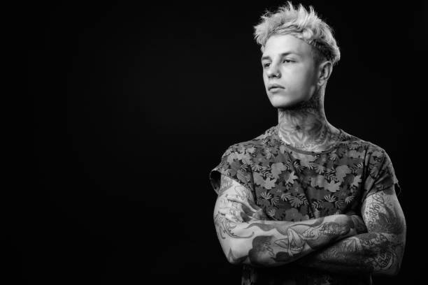 istock Young handsome rebellious man with blond hair in black and white 1330644807