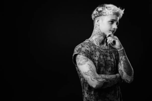 istock Young handsome rebellious man with blond hair in black and white 1330644841