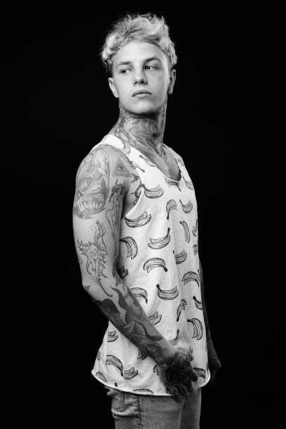 istock Young handsome rebellious man with blond hair in black and white 1330644934