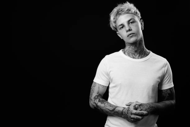 istock Young handsome rebellious man with blond hair in black and white 1330645438